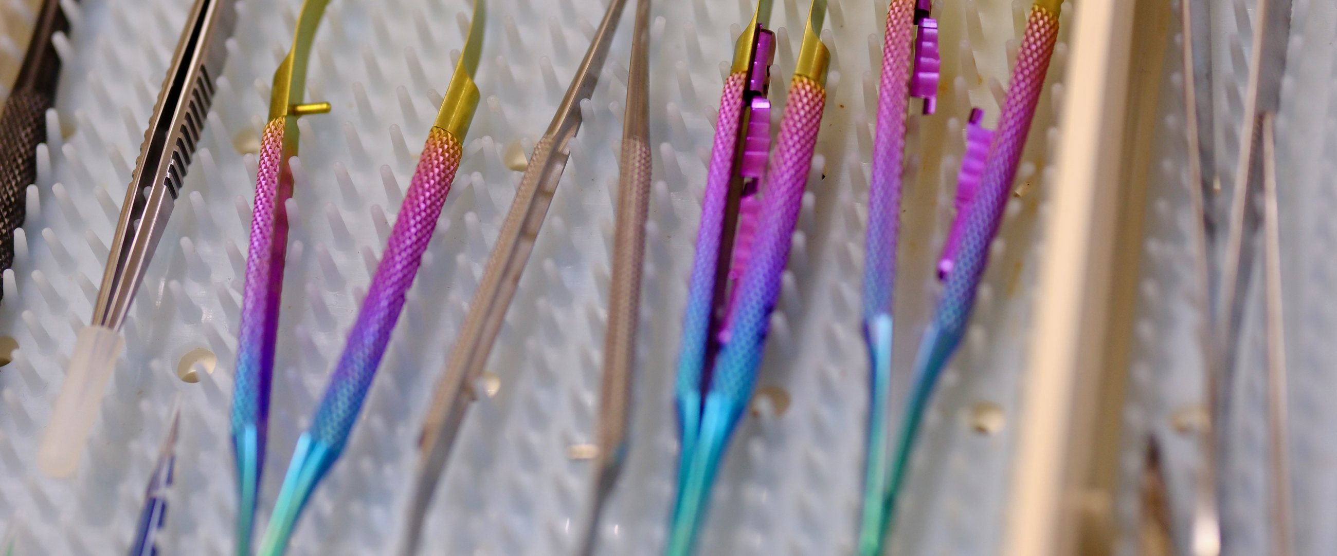 Titanium microsurgical instruments in a sterilization tray
